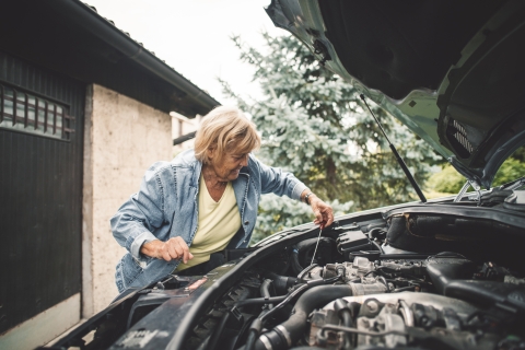 older-woman-checking-oil-level-in-car-engine