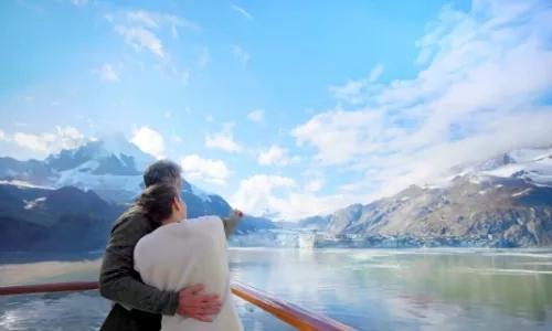 Couple onboard Holland America Line Alaska cruise looking at the horizon