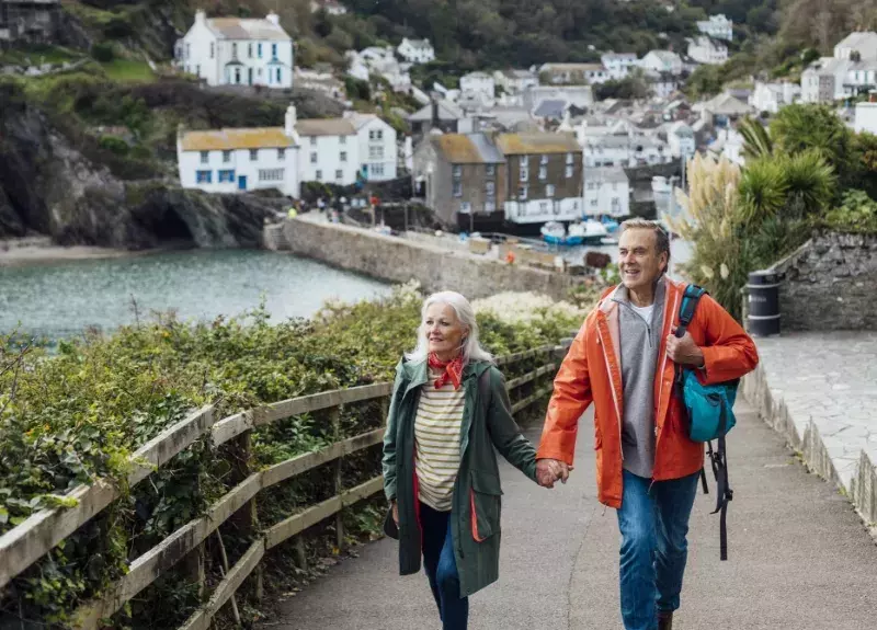 Man and woman walking hand in hand in Europe