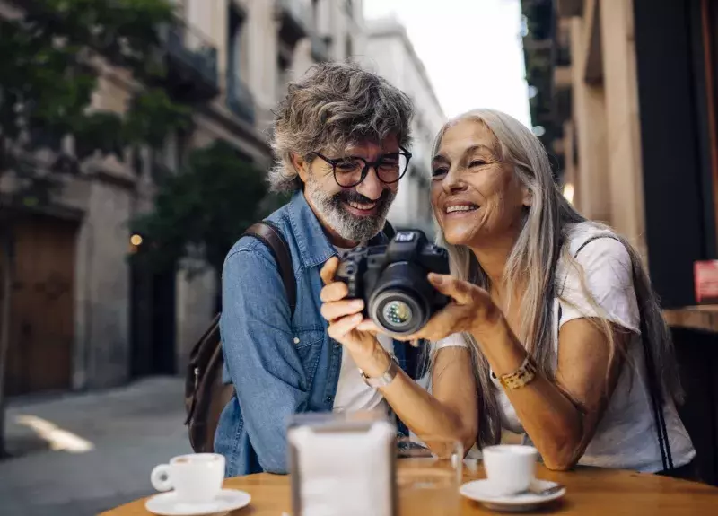 Mature couple on holiday in Europe taking photos