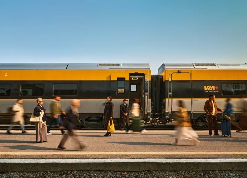 People walking alongside a VIA Rail train