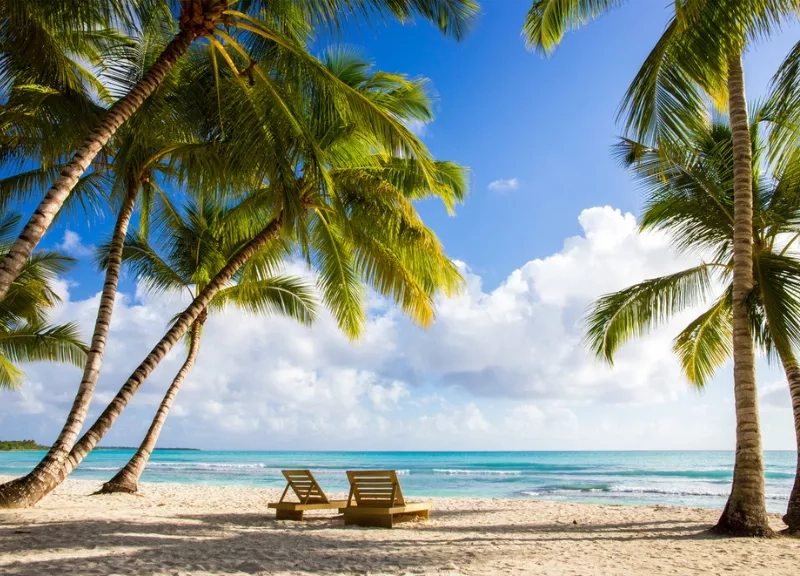 Two sun chairs facing the water on a Caribbean beach in Saona Island, Dominican Republic