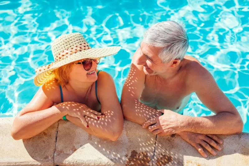 senior couple relaxing in swimming pool