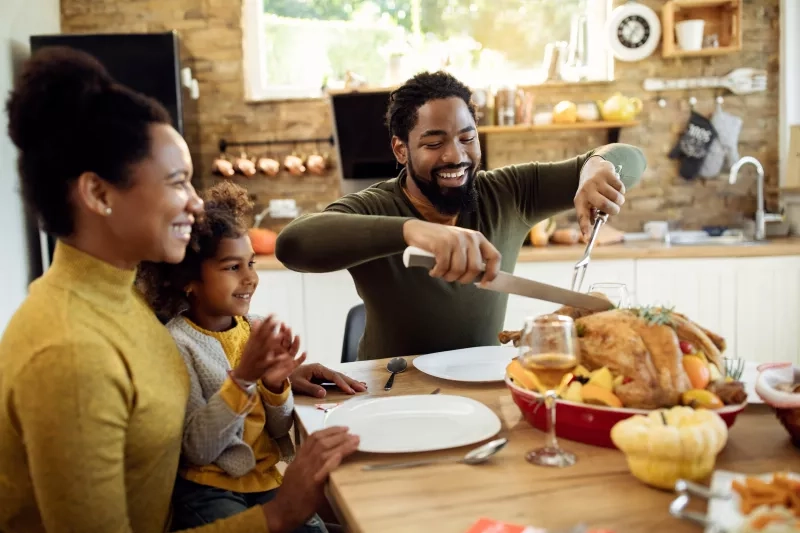 Family at a table about to eat a turkey meal