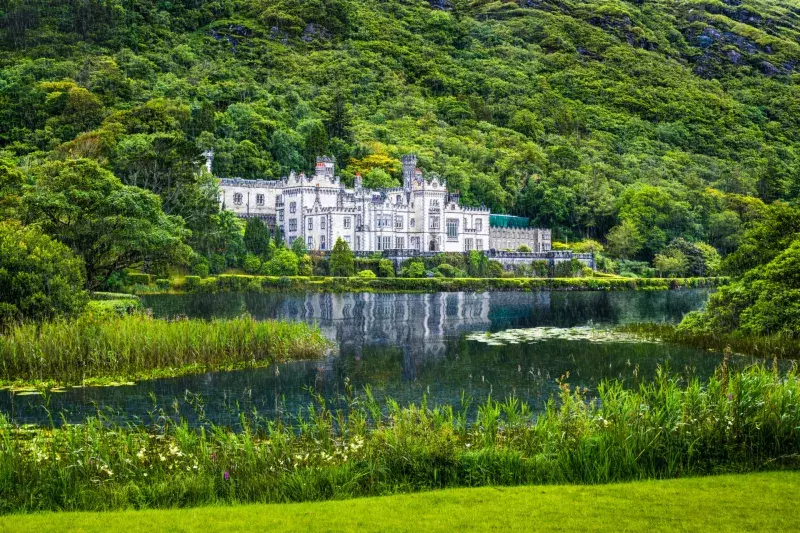 Kylemore Abbey and the surrounding forest during a rainy day, Connemara, Ireland