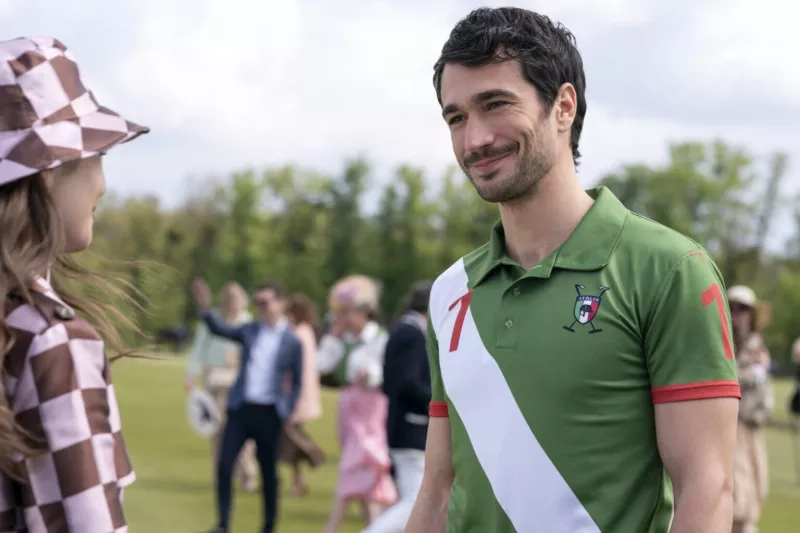 A man wearing a green golf shirt standing on a golf course