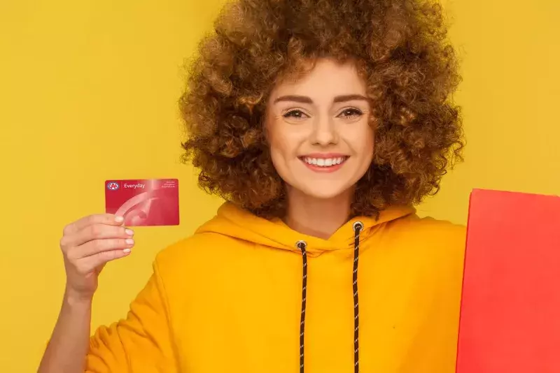 woman holding CAA card