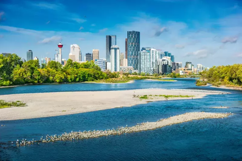 Skyline of downtown Calgary and the Bow River, Alberta Canada on a sunny morning.