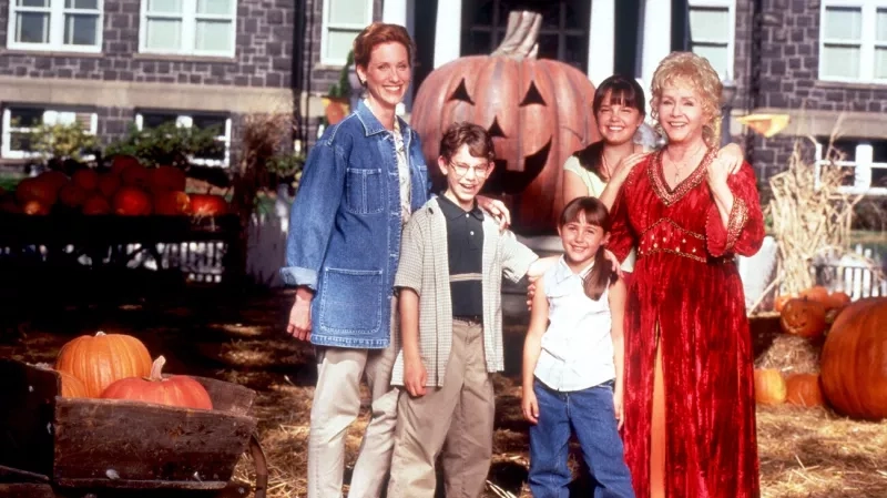 The cast of Dinsey channel original Halloweentown smiles at the camera while on set