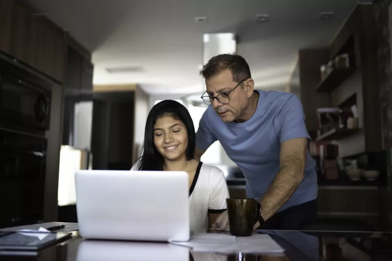 Father helping teenager with work or homework stock photo...  Save Try Crop