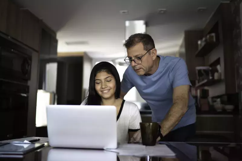 Father helping teenager with work or homework stock photo...  Save Try Crop