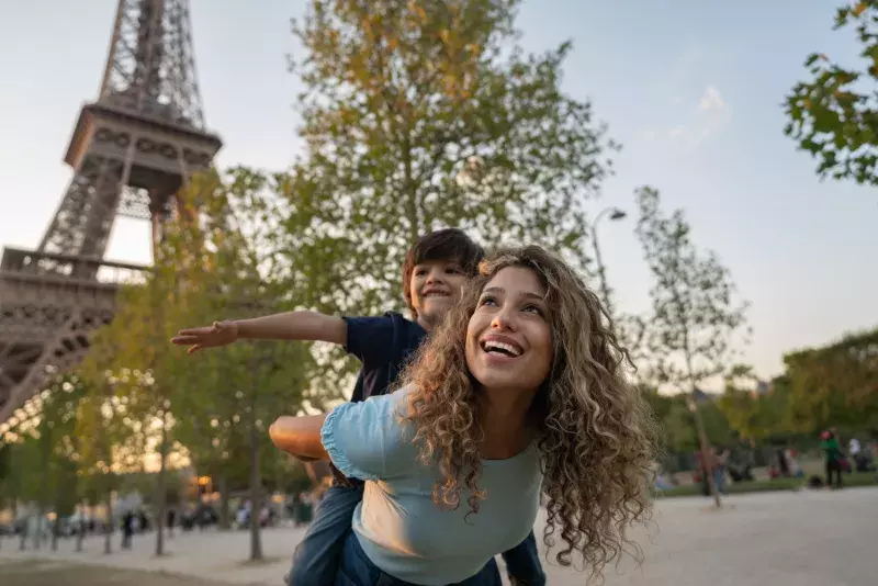 Happy mother and son traveling to Paris