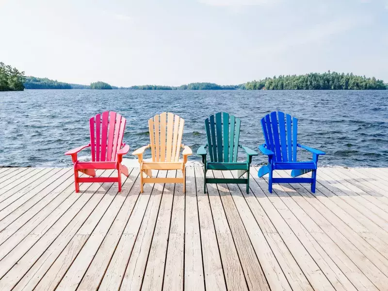 Row of multicolored Summer chairs summertime