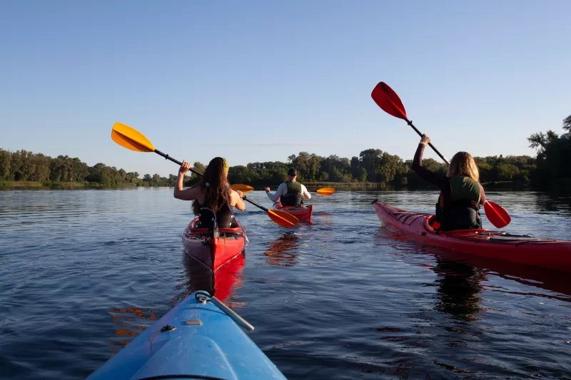 Kayaking. People paddling a kayak. Canoeing, paddling.