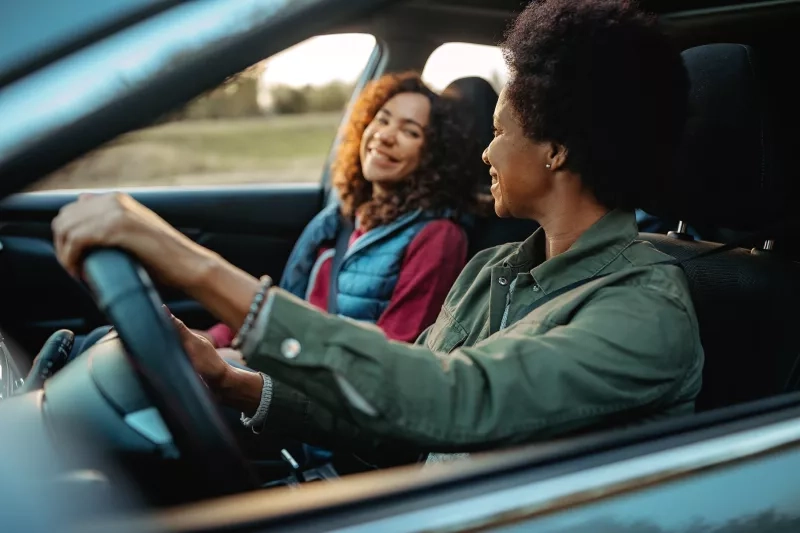 Happy family sitting in the car