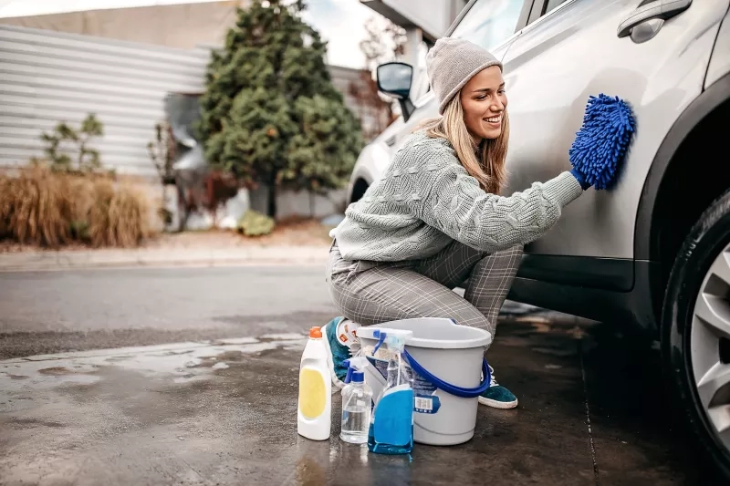 woman cleaning car