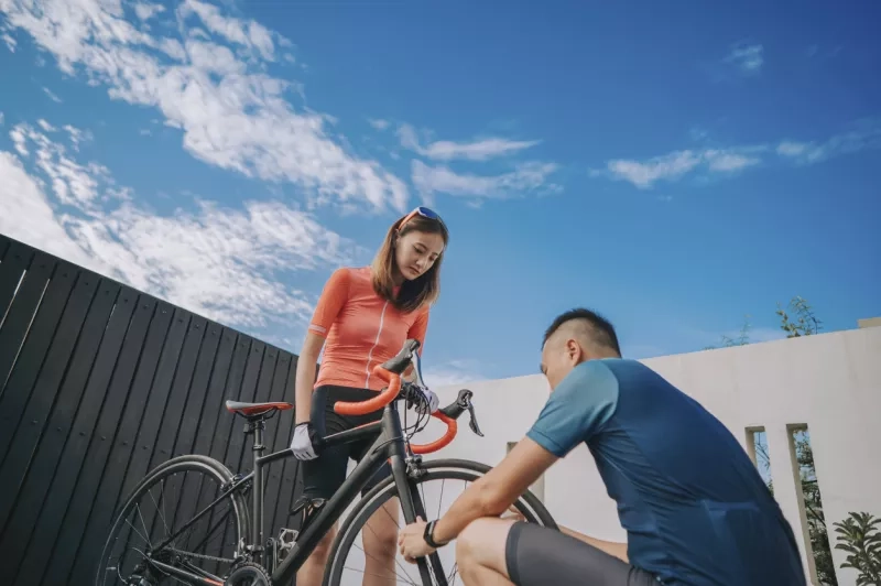 Two people inspecting a road bike