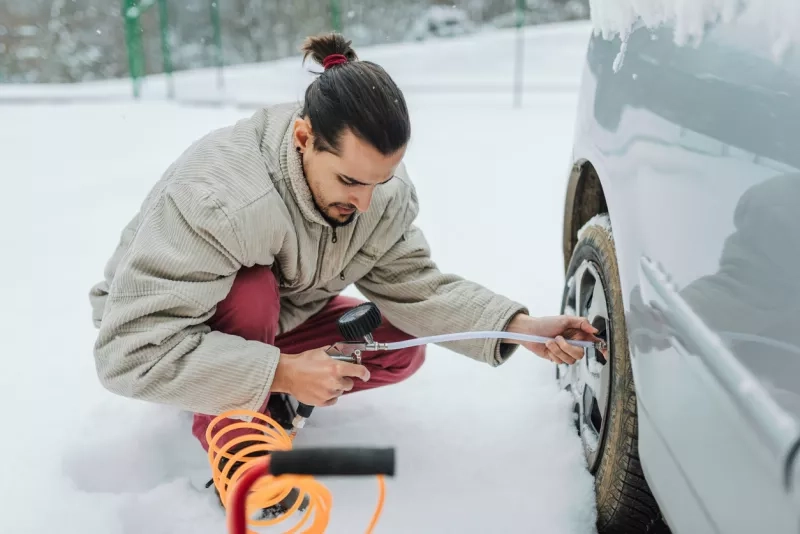 Man checking winter tires