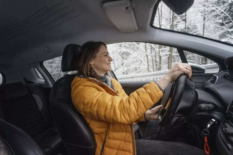 woman driving car in the winter