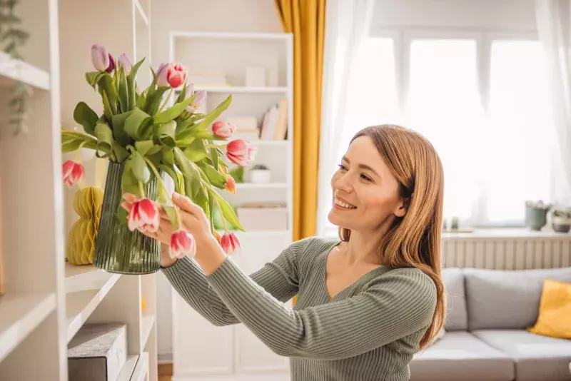 Young woman decorating apartment with Easter themed decor. Preparing for Easter.