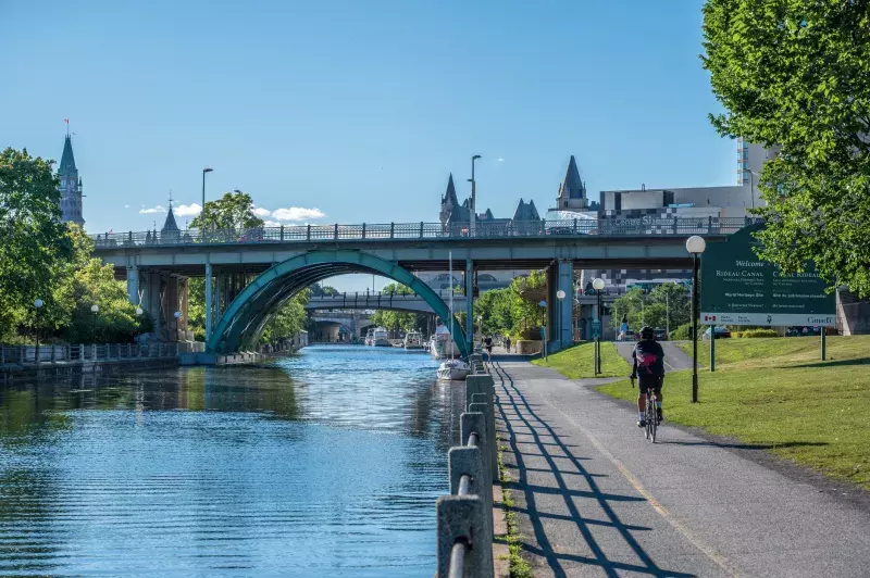 Cyclist cycling downtown Ottawa along the Rideau Canal