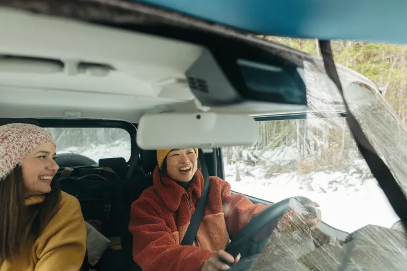 Two friends in a car in the winter