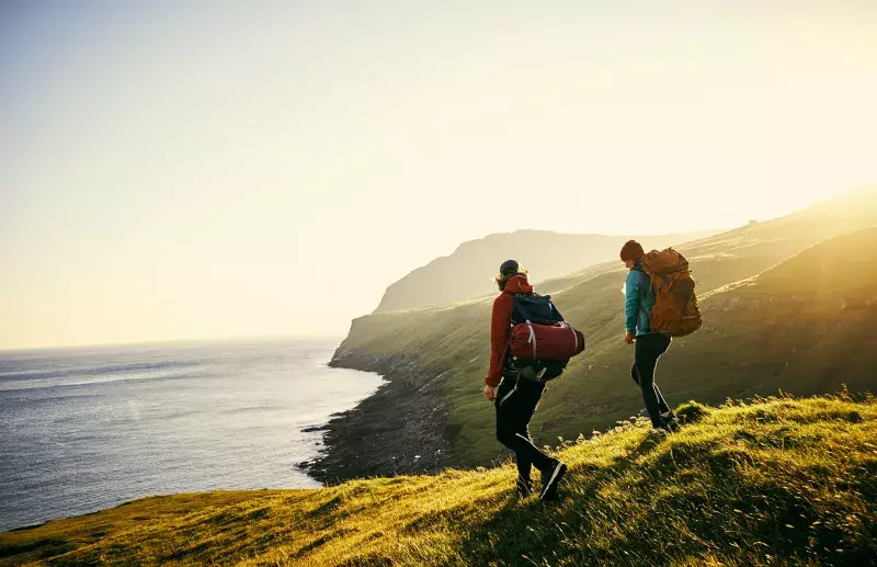 Shot of a young couple hiking through the mountains