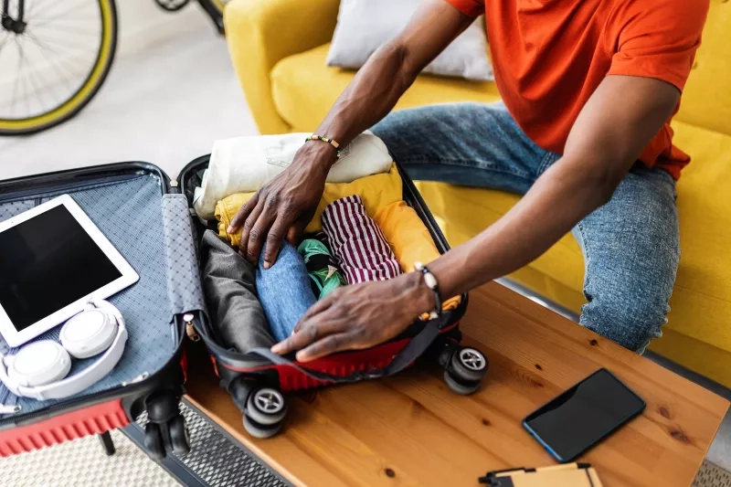 Man packing luggage before going on vacation.