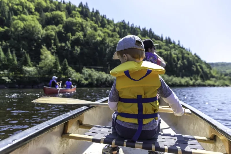 young boy and parent in a canoe