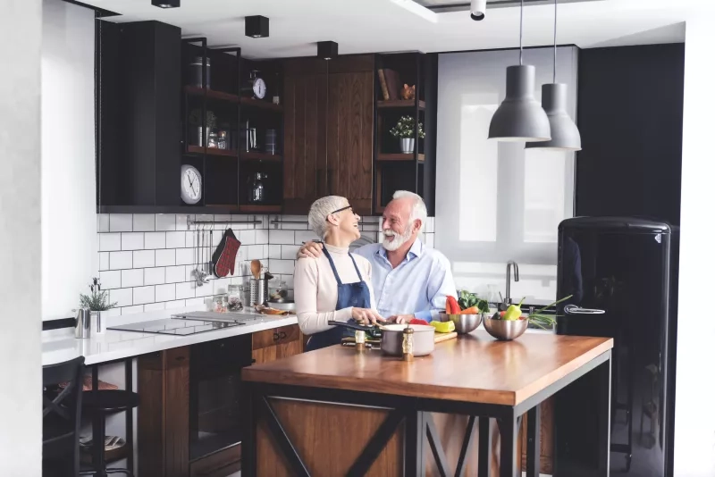 senior couple talking in a kitchen 