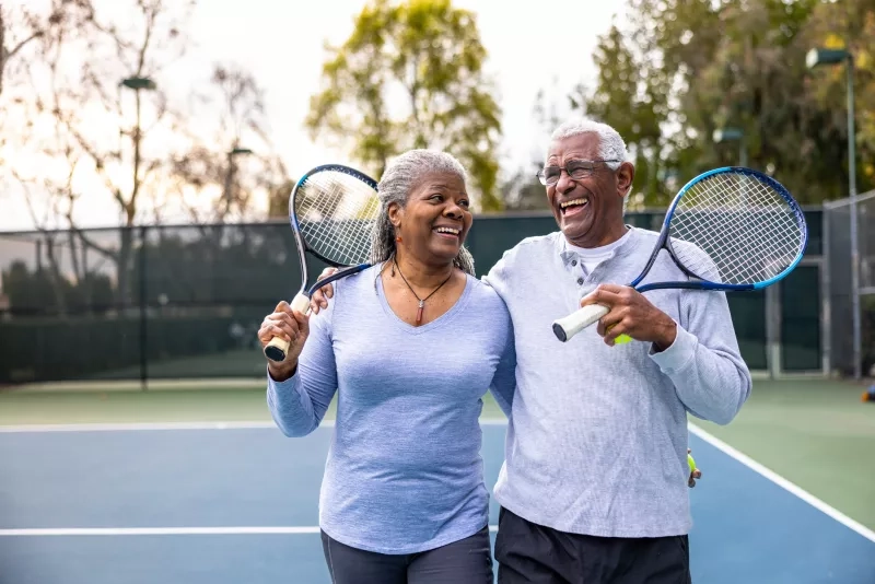 couple leaving the tennis court after their workout.