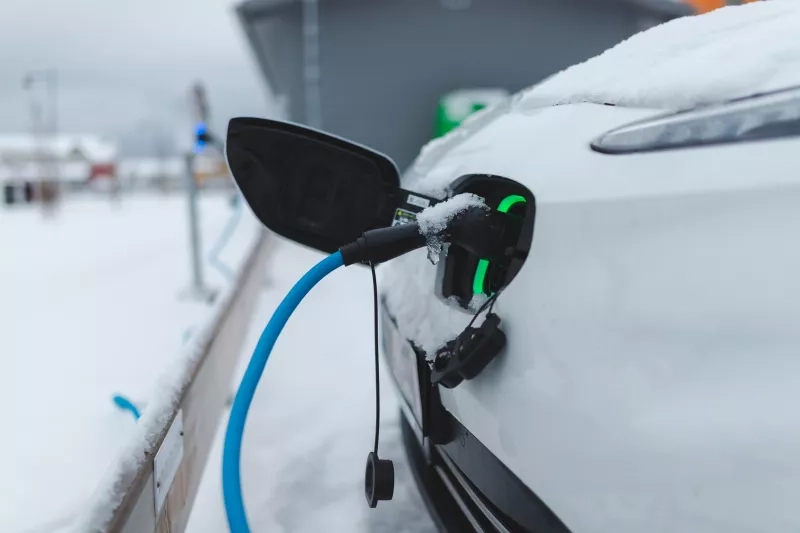 close up of an EV charging in the winter