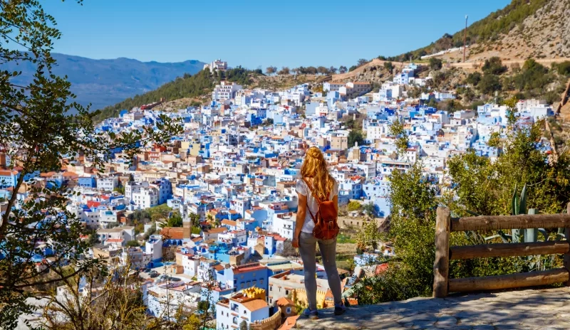 Woman tourist looking at panoramic Chefchaouen city view