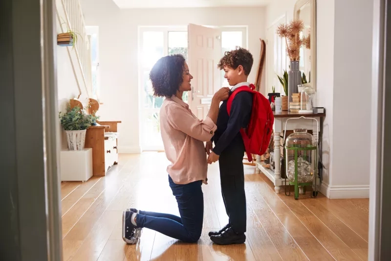 other At Home getting son wearing uniform ready for first day of school