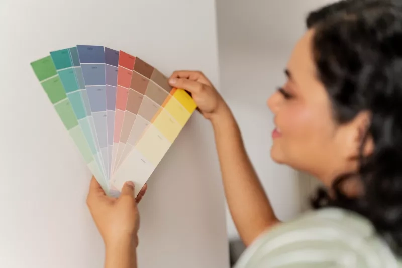 Women picking paint colour for wall
