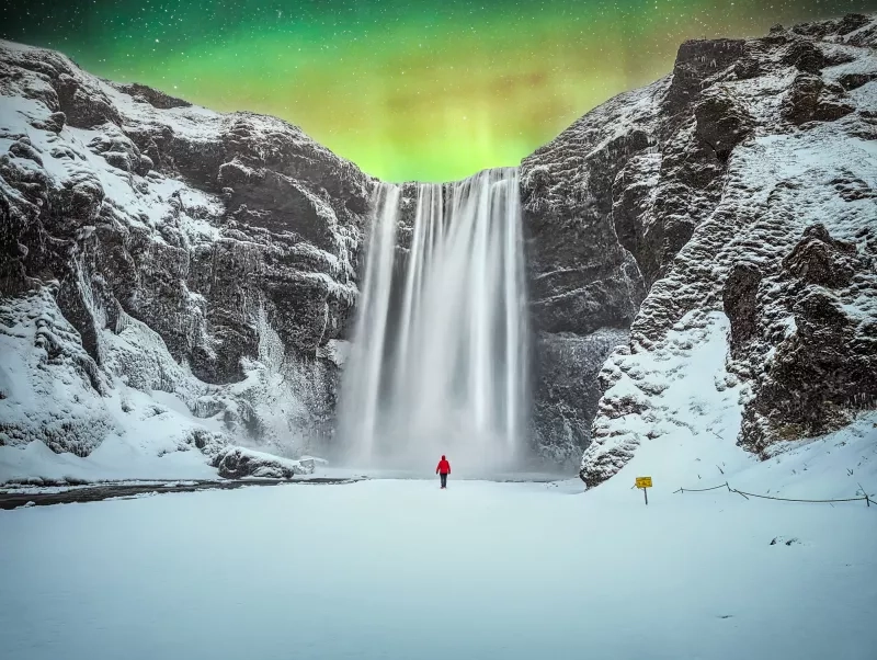 Northern Lights Over Skogafoss Waterfall in Iceland