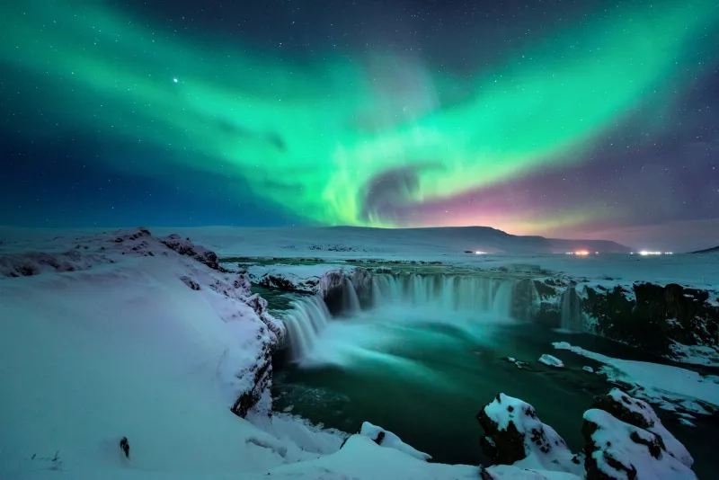 aurora above Godafoss waterfall in Iceland