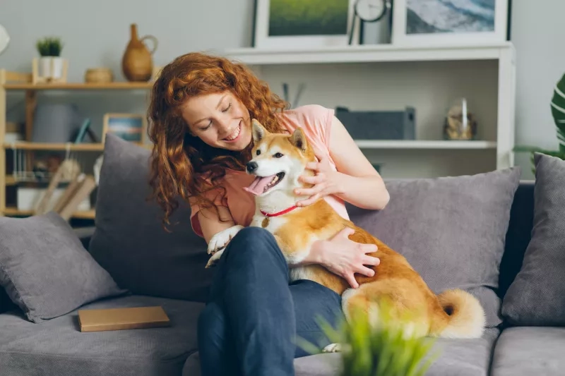 woman with dog on sofa