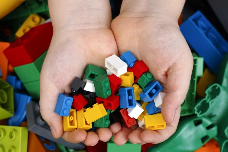 hands holding lego toys