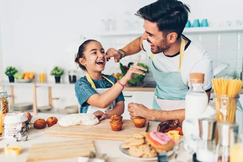 Father and daughter having fun in the kitchen 