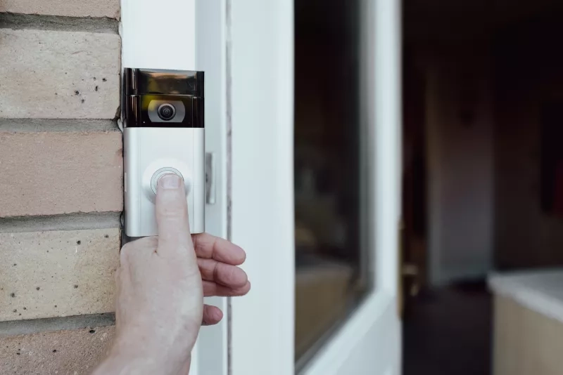 homeowner seen testing a newly installed WiFi smart doorbell