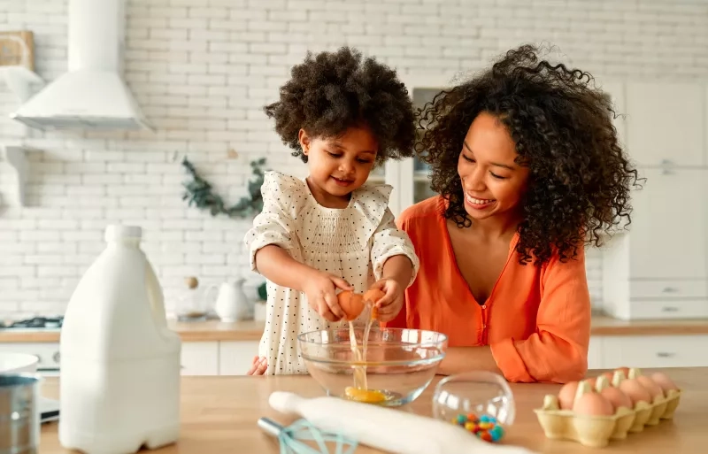 Mom and daughter cooking together