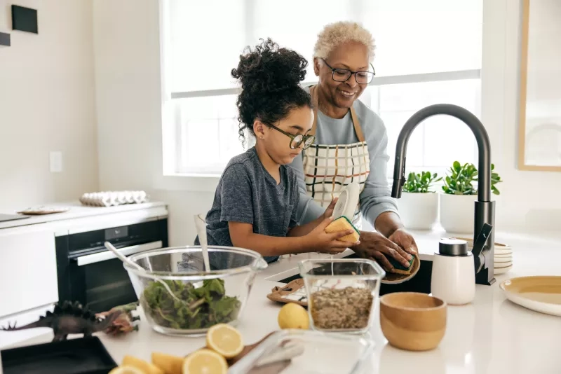 Grandmother and grandkid cooking together in the kitchen