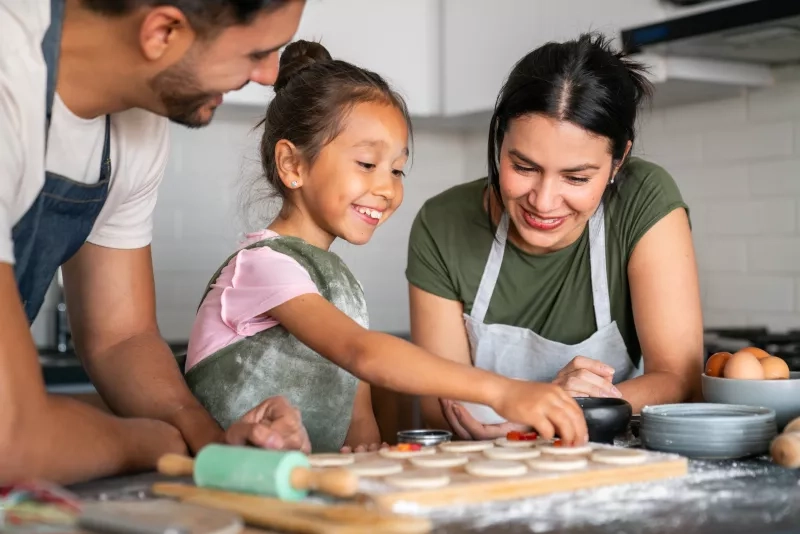 Parents and child baking together