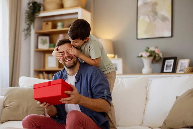 Son Covers His Father's Eyes
