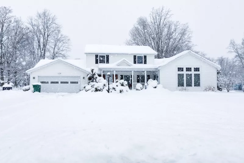 Suburban Colonial Home During Extreme Blizzard Snow Storm 