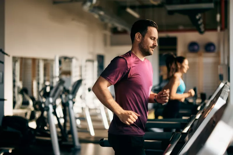 man running on a treadmill at the gym