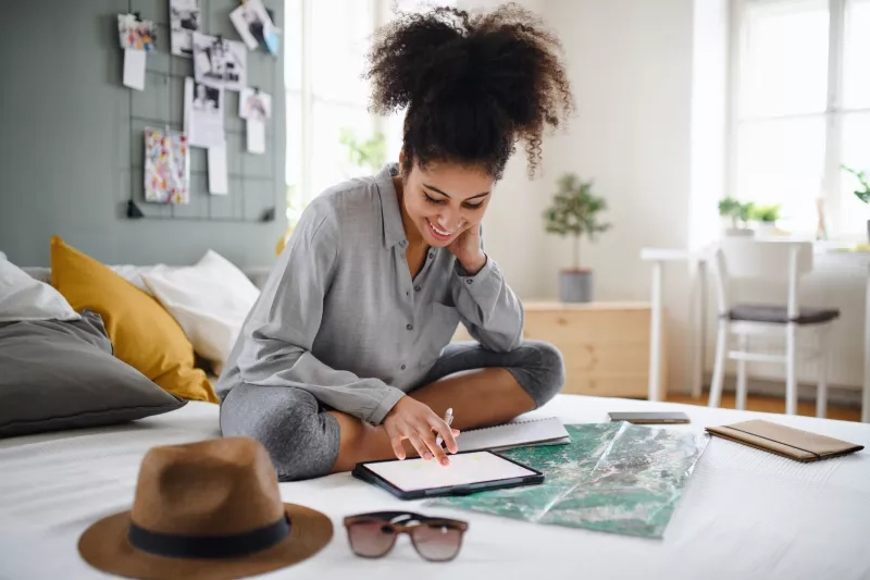 Women planning trip on tablet