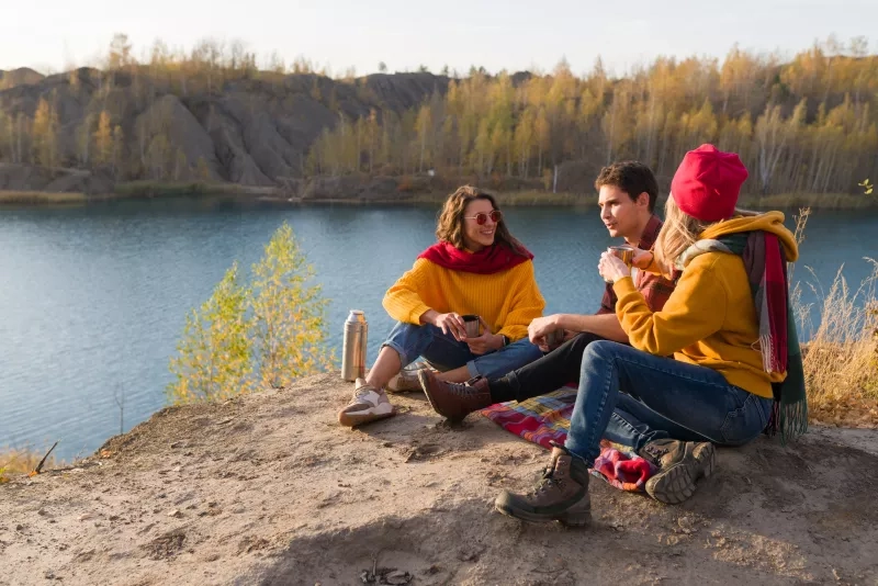group of people having a picnic next to water