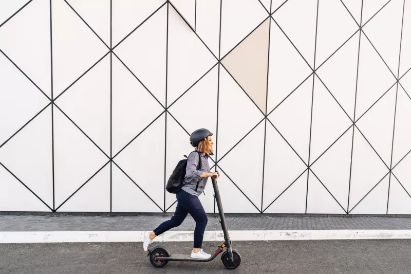 adult woman riding an electric scooter